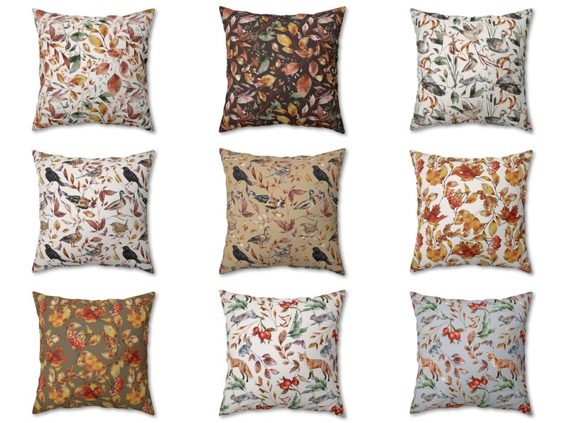 May include: Nine square throw pillows with various nature-themed patterns. Designs include autumn leaves, birds, and foxes in shades of brown, orange, and green. The pillows are arranged in a three-by-three grid.