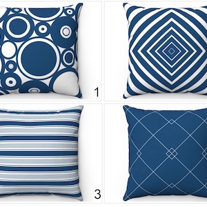 May include: Four different blue and white patterned throw pillow designs. The first pillow has a pattern of overlapping circles. The second pillow has a pattern of white stripes on a blue background. The third pillow has a pattern of white diamonds on a blue background. The fourth pillow has a pattern of white lines on a blue background.