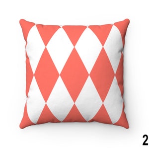 May include: A coral and white diamond patterned cushion. The cushion is made of a soft, comfortable fabric and is perfect for adding a touch of colour and style to any room.