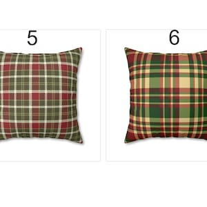 May include: Square throw pillows with plaid patterns. One pillow features a red, green, and white plaid design. The other pillow has a green, red, and tan plaid pattern. Both pillows have a white background.