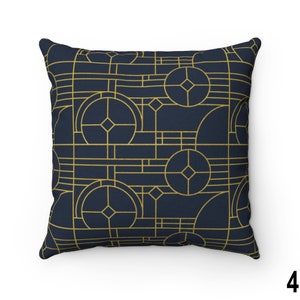 May include: A navy blue throw pillow with a geometric pattern in gold. The pattern features circles, squares, and diamonds.