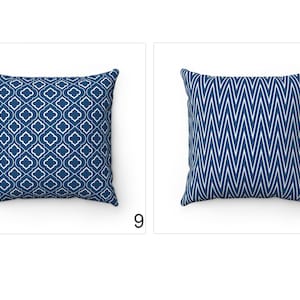 May include: Two blue throw pillows with white geometric patterns. The pillow on the left has a repeating quatrefoil design. The pillow on the right has a chevron pattern.