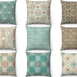 May include: Nine decorative throw pillows with a variety of geometric patterns in shades of brown, beige, and teal.