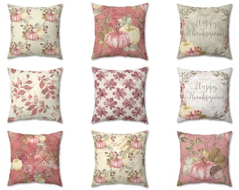 May include: Nine decorative throw pillows with various fall-themed designs. Pillows feature pumpkins, leaves, and floral patterns in shades of pink, cream, and beige. Some pillows have the text "Happy Thanksgiving".