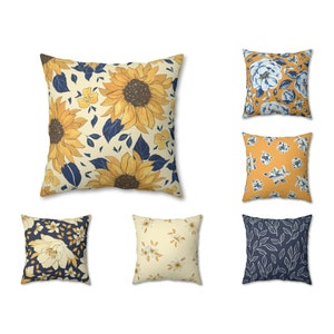 May include: Set of six decorative throw pillows featuring floral patterns in shades of yellow, blue, and white. The pillows have a variety of floral designs, including sunflowers, leaves, and small flowers.