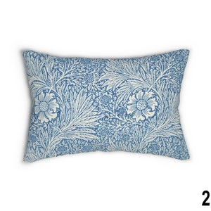 May include: A blue and white patterned throw pillow with a floral design. The pillow is rectangular and has a soft, plush feel.
