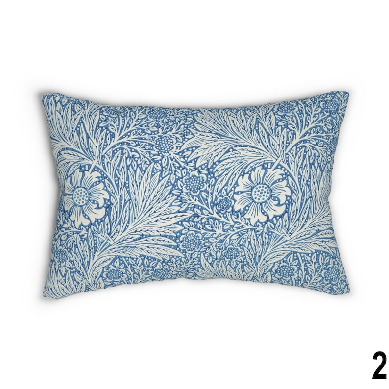 May include: A blue and white patterned throw pillow with a floral design. The pillow is rectangular and has a soft, plush feel.