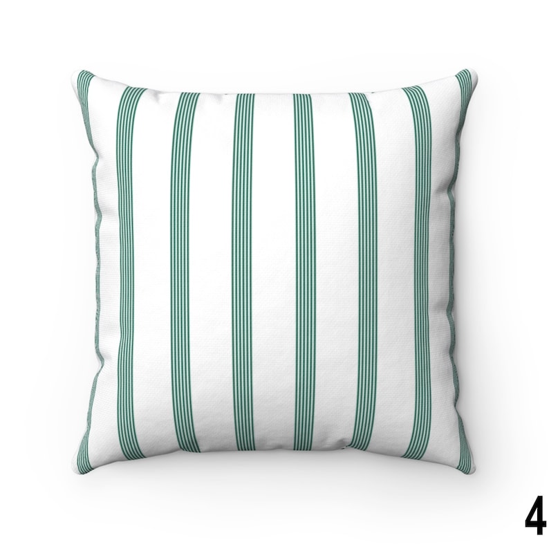 May include: A white throw pillow with green stripes. The pillow is made of a soft, comfortable fabric and is perfect for adding a touch of style to any room.