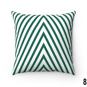 May include: A green and white striped throw pillow with a chevron pattern. The pillow is made of a soft, comfortable fabric and is perfect for adding a touch of style to any room.