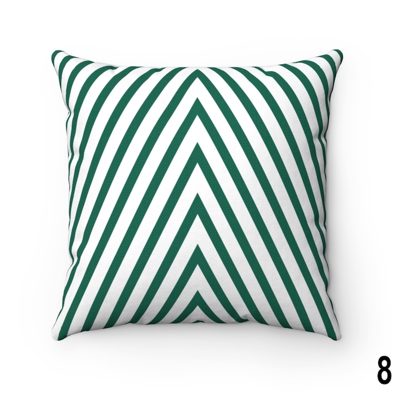 May include: A green and white striped throw pillow with a chevron pattern. The pillow is made of a soft, comfortable fabric and is perfect for adding a touch of style to any room.