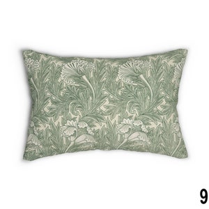 May include: A rectangular throw pillow with a green and white floral pattern. The pattern features stylized leaves and flowers.