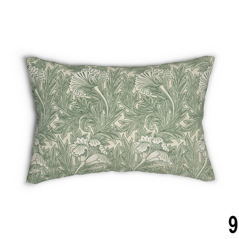 May include: A rectangular throw pillow with a green and white floral pattern. The pattern features stylized leaves and flowers.