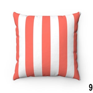 May include: A coral and white striped throw pillow. The pillow is made of a soft, comfortable fabric and has a square shape.