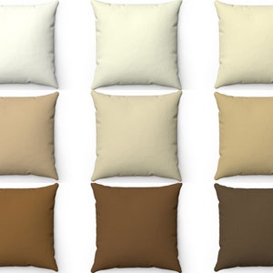 May include: Nine square throw pillows in various shades of beige, brown, and cream. The pillows are arranged in three rows of three, with the lightest color at the top and the darkest color at the bottom.
