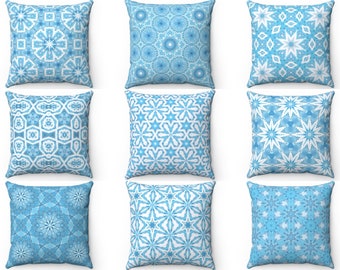 May include: Nine blue and white patterned throw pillows with geometric designs. The pillows are arranged in three rows of three.