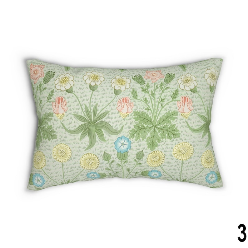 May include: A rectangular pillow with a floral pattern. The pillow features a light green background with pink, yellow, and blue flowers. The flowers are stylized and have a vintage look.