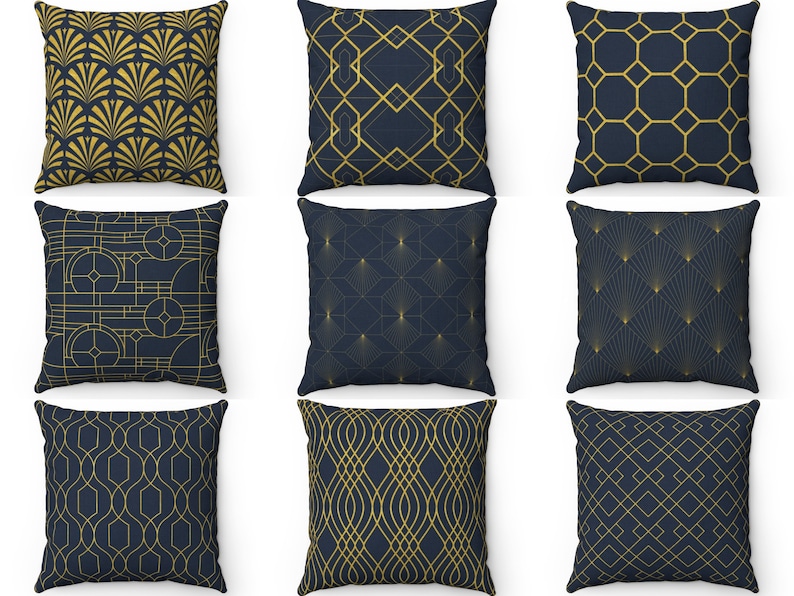 May include: Nine decorative throw pillows with geometric patterns in gold and navy blue. The pillows are arranged in three rows of three.