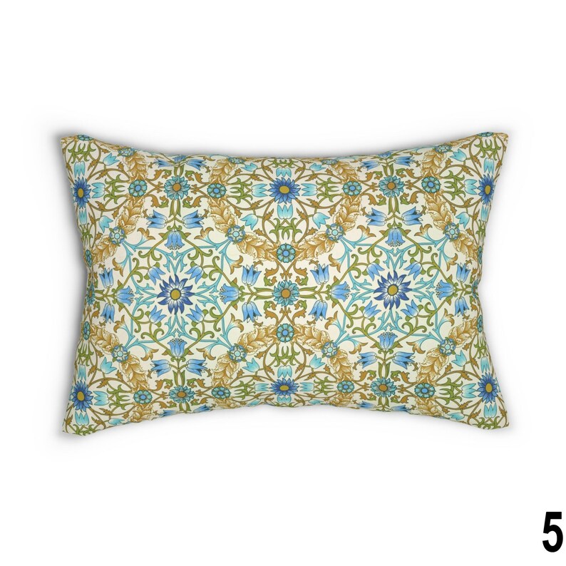 May include: A rectangular throw pillow with a cream background and a repeating pattern of blue and gold flowers and leaves.