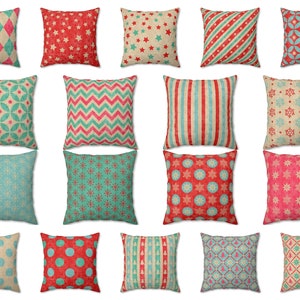 May include: Collection of decorative throw pillows with various patterns. Designs include stars, stripes, snowflakes, polka dots, and geometric shapes in red, teal, and beige. The pillows are square and made of a textured fabric.