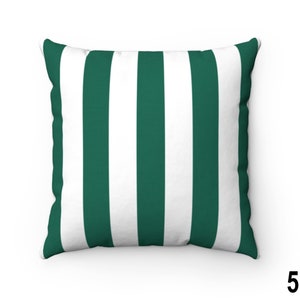 May include: A green and white striped throw pillow. The pillow is made of a soft, comfortable fabric and has a square shape.