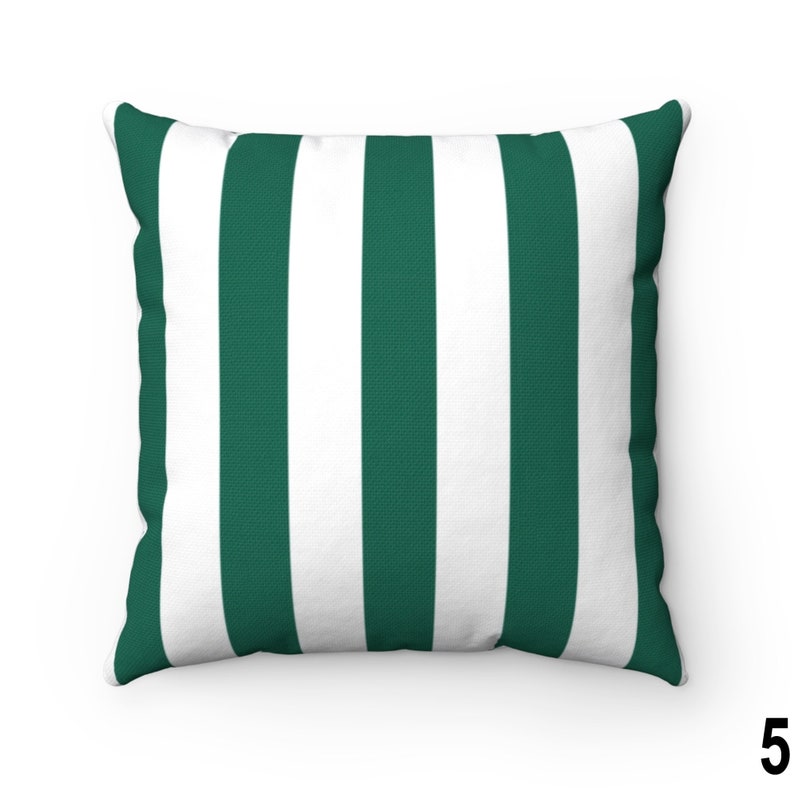 May include: A green and white striped throw pillow. The pillow is made of a soft, comfortable fabric and has a square shape.