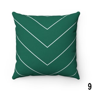 May include: A green throw pillow with a white chevron pattern.