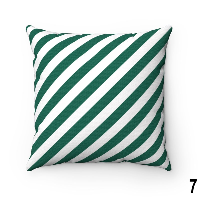 May include: A green and white striped throw pillow with a diagonal pattern. The pillow is made of a soft, comfortable fabric and is perfect for adding a touch of style to any room.