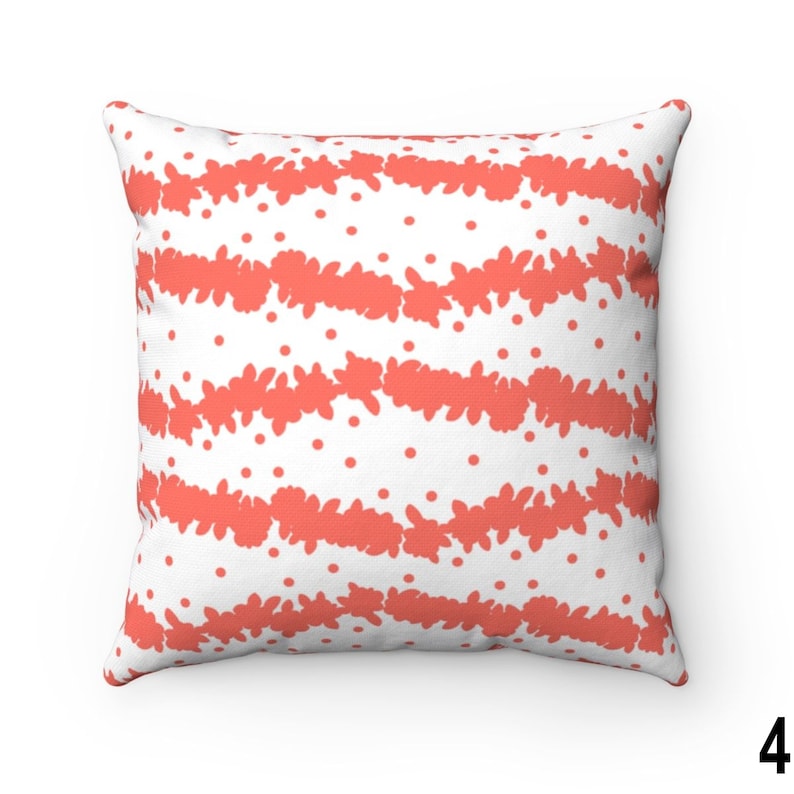 May include: A coral and white patterned throw pillow with a geometric design. The pillow is square and has a white background with coral coloured stripes and dots.