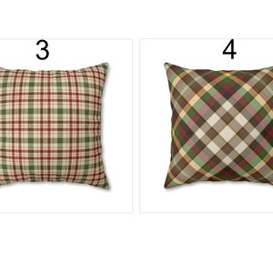 May include: Two square throw pillows with plaid patterns. One pillow features a green, red, and beige plaid design. The other pillow has a diagonal plaid pattern in shades of green, red, beige, and gold. The pillows are displayed on a white background.