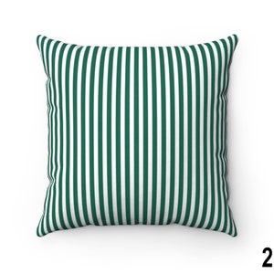 May include: A green and white striped throw pillow. The pillow is made of a soft, comfortable fabric and has a square shape.