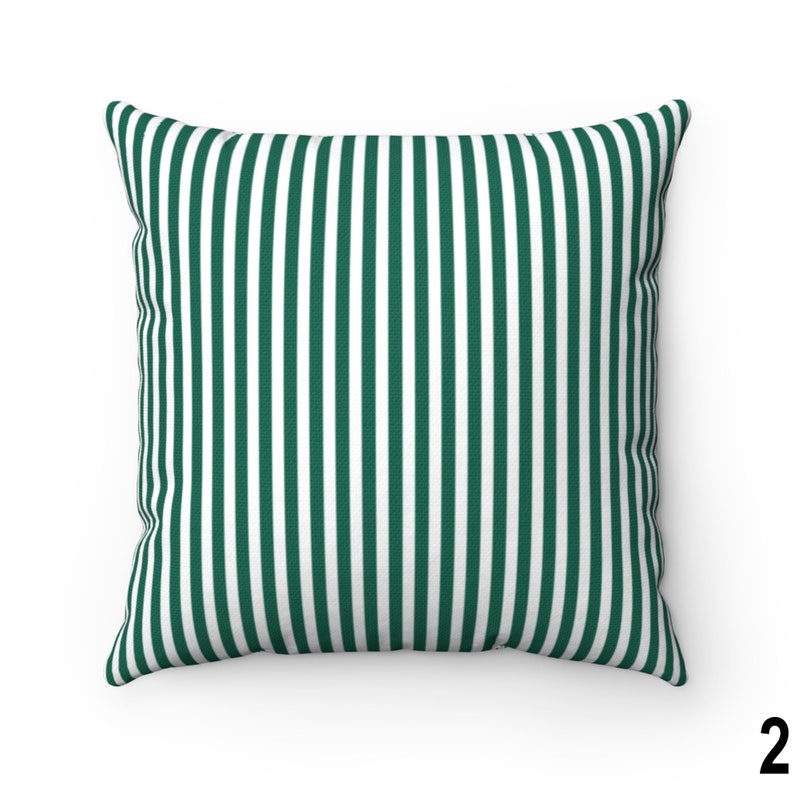 May include: A green and white striped throw pillow. The pillow is made of a soft, comfortable fabric and has a square shape.