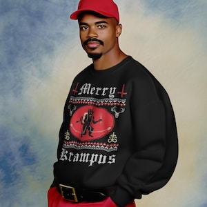 May include: A black long-sleeve sweatshirt featuring a red oval graphic with a Krampus illustration, the text Merry Krampus, and decorative symbols. The sweatshirt is paired with a red baseball cap and red trousers with a black belt and gold buckle.