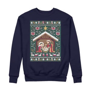 May include: Navy blue sweatshirt with a Christmas-themed knitted design. The design depicts a nativity scene with Mary, Joseph, and baby Jesus, surrounded by stars, reindeer, and snowflakes. The sweatshirt is a comfortable, long-sleeved garment.