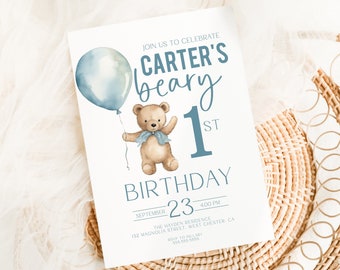 May include: A blue and white invitation card with a teddy bear holding a blue balloon. The text on the card reads "Join us to celebrate Carter's beary 1st Birthday, September 23, 4:00 PM, The Hayden Residence, 132 Magnolia Street, West Chester, CA".