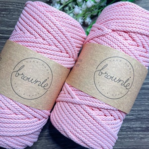 May include: Two spools of pink cotton rope, each with a brown paper label that reads "hand made brownie knit & knot".