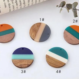 May include: Four round wooden pendants with different colored resin inlays. The pendants are numbered 1 through 4. Each pendant has a hole at the top for hanging.