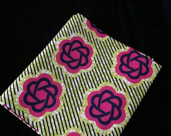 May include: Green and white fabric with a repeating pattern of pink and navy blue stylized flowers. The flowers have a knotted design in the center.