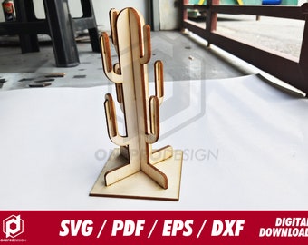 May include: A wooden cactus sculpture with a square base and multiple arms. The cactus is made of light-colored wood and has a natural finish. The image also includes the text "SVG / PDF / EPS / DXF DIGITAL DOWNLOAD".