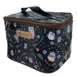 May include: A black zippered travel bag with a brown handle and a brown trim. The bag is covered in a pattern of owls and flowers. The bag has a label that says "uma hana made in taiwan".