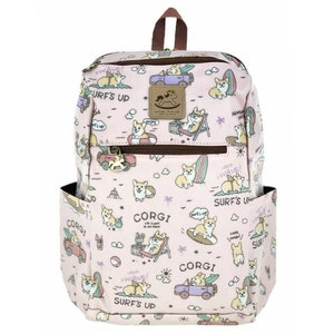 May include: Pink backpack with a cartoon corgi design. The backpack features a variety of corgis in different poses, including surfing, driving cars, and relaxing on the beach. The text "Surf's Up" and "Corgi" are repeated throughout the design.