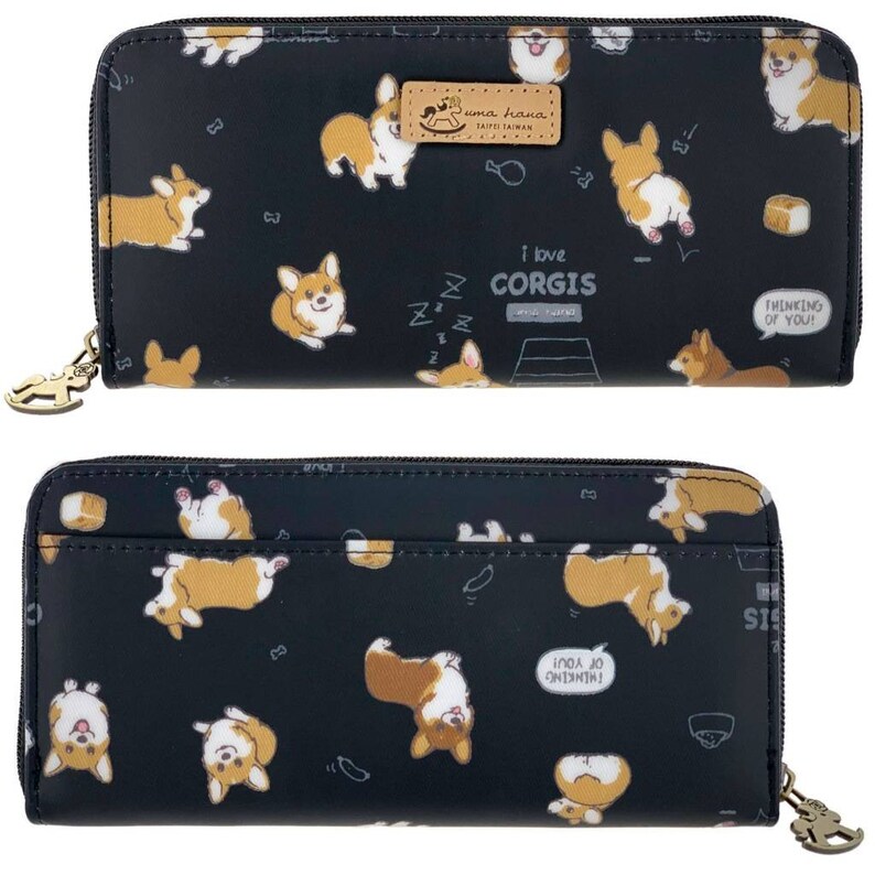 May include: Black zippered wallet with a repeating pattern of cartoon corgis in various poses. The wallet has a gold zipper pull with a small corgi charm. The text "I love corgis" is printed on the front of the wallet.