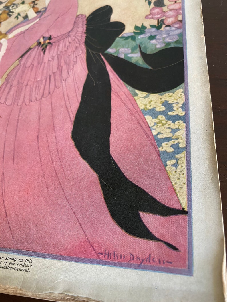 May include: A vintage illustration of a woman in a pink dress with a black bow. The woman is standing in a garden with flowers. The illustration is signed "Helen Dryden".