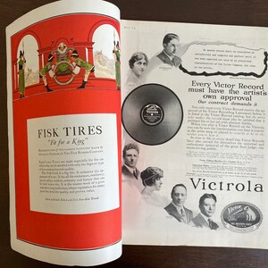 May include: A vintage magazine advertisement spread featuring a Fisk Tires illustration with a king on a throne on the left page and a Victrola record player advertisement with black and white portraits of people on the right page.