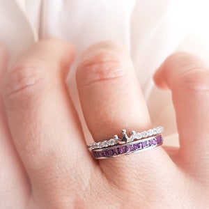 1 carat princess-cut channel set sterling silver ring with brilliant simulated amethyst CZ stones, beautifully packaged in a ribbon-tied gift box. Elegant and versatile band perfect for stacking, wearing alone, or pairing with an engagement ring