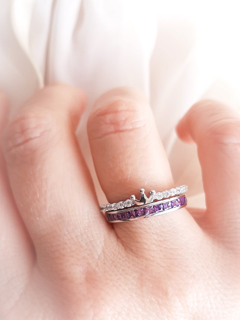 1 carat princess-cut channel set sterling silver ring with brilliant simulated amethyst CZ stones, beautifully packaged in a ribbon-tied gift box. Elegant and versatile band perfect for stacking, wearing alone, or pairing with an engagement ring