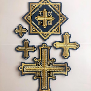 May include: Set of five gold embroidered patches featuring crosses and a star with a cross inside. The patches are on a blue background and have gold embroidery with the words "IC XC" and "NH KA" in the center.