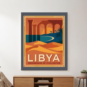 May include: A rectangular wall poster featuring a stylized illustration of Libya with orange sand dunes, a blue coastline, palm trees, and ancient stone arches. The text LIBYA and CROSSROADS OF CIVILIZATION is printed in white at the bottom.