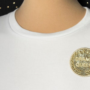 DRAMA QUEEN gold medal brooch trompe l&#39;oeil offbeat humor gold glitter fabric embroidered message in English gold thread made in France