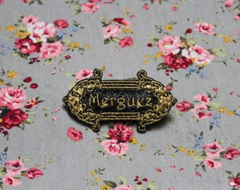 Brooch jewel Merguez "The precious distinguished baroque" fabric black sequins message embroidered in Arabic golden thread made in France