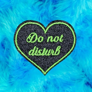 Brooch heart Do not disturb, black sequin fabric, embroidery thread green color neon lime, message embroidered in English, made in France